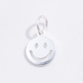 Macro shot of silver hollow smiley face pendant with polished metallic finish - White Gold Smile Face Pendant
