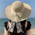 Beige woven straw sun hat for women featuring a delicate white lace bow detail - Large Brim Flower Style - Beige