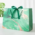 Green marble pattern gift bag with satin ribbon bow and gold sand texture design - Green Flowing Gold