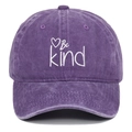 Detailed close-up of Be Kind heart embroidery on vintage washed purple cotton baseball cap - Purple