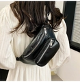 Detail of black PU leather chest bag with dual zippers and stylish chain on a white dress - Black