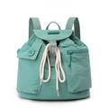 Detail of mint green nylon backpack showing drawstring closure and flap pocket with stitching - Azure Green