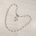 Detail of freshwater pearl necklace with silver chain shaped into a heart on wood background - Silver/Freshwater Pearl