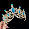 Golden Baroque crown with blue gemstones and clear crystals shown on a dark background - Standard Size / Gold Lake Blue Zircon
