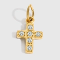 Macro shot of small gold-plated cross pendant with five sparkling zircon stones - Cross