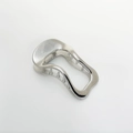 Close-up of a silver wavy alloy hair clip with a metallic finish on a white background - Silver
