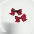 Pair of deep red satin ribbon bow hair clips with black metal attachment on a white plate - Duckbill Clips (Pair) / Burgundy