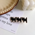 Three linked black cat hair clips with gold lettering on cream vintage paper card - Black Dog