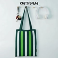 Chic green and white striped knitted tote bag hanging on a minimalist wooden wall hook - Dark Green Striped