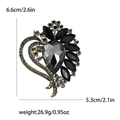Ornate heart-shaped brooch with black faceted crystals and antique gold finish specifications - Black