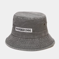 Close-up of washed gray denim bucket hat featuring white FOUNDED1986 embroidery patch - M (56-58cm) / Gray