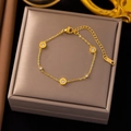Macro shot of gold-plated titanium bracelet with Roman numerals and cubic zirconia - Roman Dial Gold