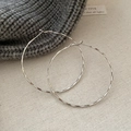 Detailed view of silver hoop earrings with irregular hammered texture on beige fabric - 6cm Large Hoop (6#)