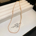Close-up of a pink pearl necklace with golden clasp on a premium beige velvet display tray - Pink Gold Plated Style (37#)