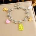 Detail of a charm bracelet with golden bears and hearts on a brushed jewelry box display - Heart Bear Pearl Style (B1822)