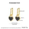 Detailed view of heart-shaped lock earrings with black enamel and quilted pattern gold hoops - Gold-Black