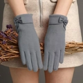 Detail of grey winter gloves for women with decorative bow and soft plush fleece material - One Size / Leather Bow Grey