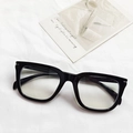 Classic black square frame glasses with silver accents on soft white textile - Black