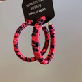 Detailed close-up of 925 silver hoop earrings featuring red and black tiger pattern design - Large Circle / Tiger Print Red (Silver Earring Post)