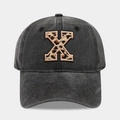 Detail of vintage washed charcoal baseball cap featuring leopard print letter X embroidery - Letter X