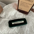 Close-up of a vintage dark green velvet hair clip with silver metal detail on white paper - Square / Dark Green