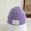 Detail of light purple ribbed knit beanie for kids with white lettered decorative patch - 1-4 Years / Taro Purple