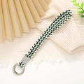 Green and white woven wrist strap with silver metal clasp on a minimalist background - 12mm Width / Green/White