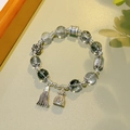 Green phantom quartz bracelet with silver charms and tassel in a variant close-up - 12mm Green Ghost: Simple Style Tassel Fortune Bag