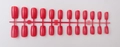 Detail view of 24 pieces of long square glossy magenta press-on nails on a red holder - Bright Red (CFL-23)