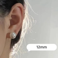Detailed view of 12mm white pearl stud earring on model with elegant glossy finish - 12mm