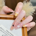 Detail of almond-shaped press-on nails featuring cat motifs and plaid patterns on model - By1941 Catfoot Disappearance / Glue Type