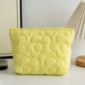 Detail of quilted floral cosmetic bag in yellow fabric with fluffy padding texture - Yellow