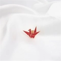 Elegant red enamel origami crane brooch with gold trim on white satin fabric background - Paper Crane Red (90240B)