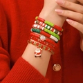 Close-up of Christmas clay bead bracelet set with Santa charm worn on red knit sleeve - SY0660/Polymer Clay and Crystal Bead Combo