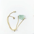 Detail of adjustable gold chain bracelet with raw green crystal and slide clasp - Fluorite