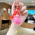 Rode dolfijn sleutelhanger met roze glitter vloeistof en een gouden metalen belletje - Dolfijn-Rood