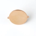 Macro detail of rose gold mirror polished round stainless steel blank charm with dual holes - Rose Gold / Diameter 25mm