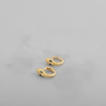 Detailed macro shot of golden snake-shaped earrings featuring sparkling blue gemstone eyes - Gold (Blue Eyes)