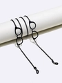 Detail of black eyewear chain with mini resin glasses charm on a white display stand - Black