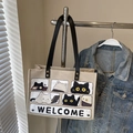 Beige Canvas-Tragetasche mit Katzenprint, schwarzen Griffen und Metallnieten - Schwarz