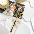 Close-up of a gold acrylic mirror rose cake topper on a romantic wedding table - Hollow Rose
