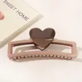 Macro detail of large square heart hair claw clip in matte lotus pink finish - Heart Hollow Rectangle / Coffee