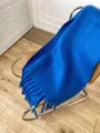 Thick Klein blue mohair scarf with fringe tassels on a brown leather chair - Klein Blue