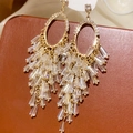 Detail of vintage gold bow earrings with crystal tassels on brown leather background - 16# Gold Oval Crystal Tassel Studs