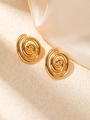 Macro shot of gold-plated spiral titanium steel earrings on a soft silk fabric background - Gold Spiral Swirl Stud Earrings