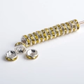 Macro shot of silver plated rondelle spacer bead with yellow crystals for DIY jewelry - Silver Plated Yellow Rhinestone