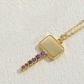 Golden key-shaped necklace featuring polished rectangular pendant with purple zircons - Large Key / Gold with Purple Zircon
