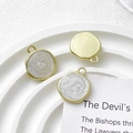 Detailed macro view of gold enamel round disk charms for DIY jewelry crafting - White