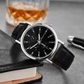 Close-up of Ganwa black dial quartz watch with silver case on leather notebook - Black Dial Black Strap Three-Eye Style