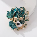 Vintage venetian mask brooch with blue enamel leaves and a polished golden frame - Blue